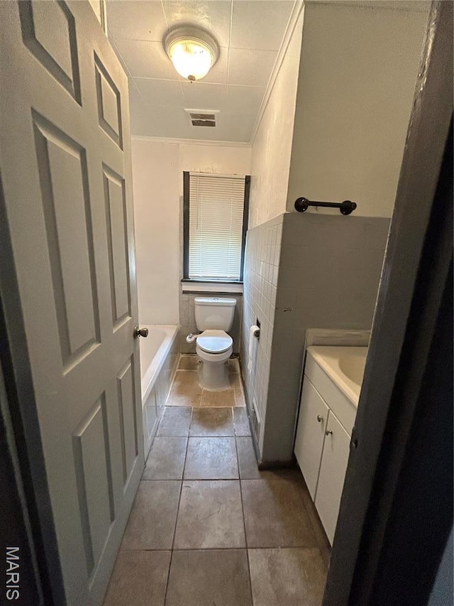 10140 Mayfair Dr, Saint Louis, MO 63136 - bathroom featuring toilet, vanity, a bathtub, and tile patterned floors