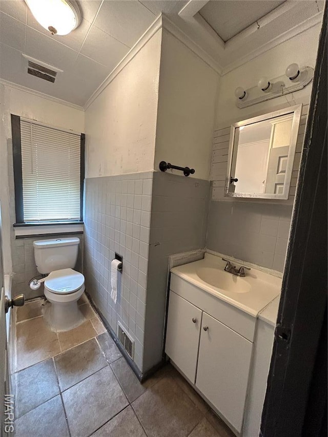 10140 Mayfair Dr, Saint Louis, MO 63136 - half bathroom featuring crown molding, toilet, tile walls, vanity, and wainscoting