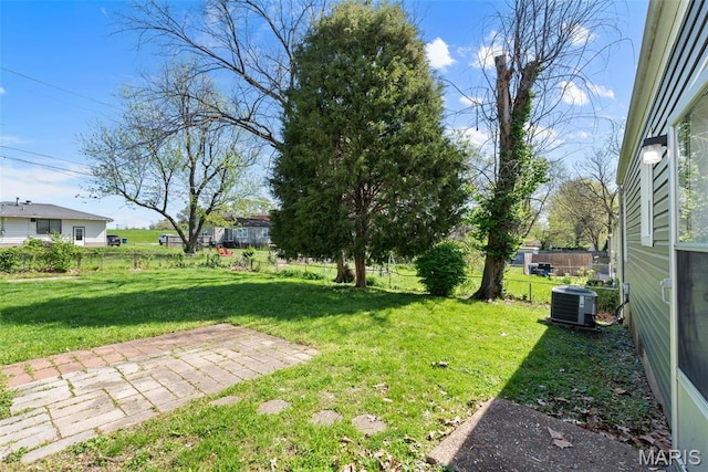view of yard with central AC and a patio area