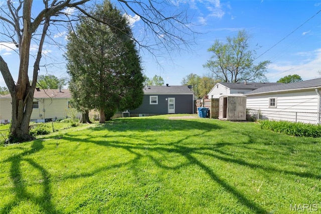 view of yard featuring a shed and an outbuilding