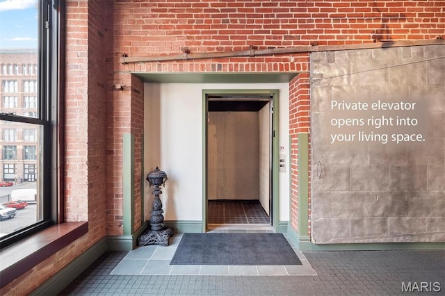 property entrance featuring brick siding