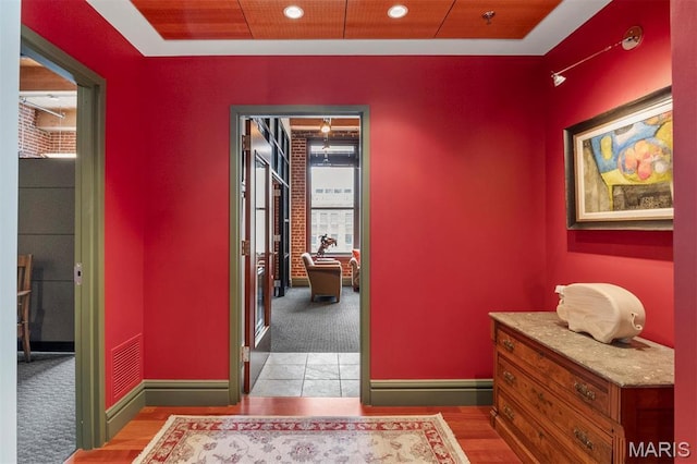 corridor featuring light colored carpet, baseboards, and recessed lighting