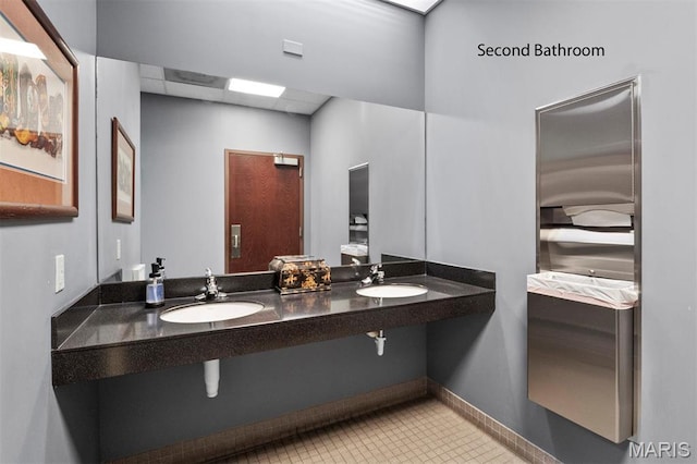 bathroom with tile patterned flooring and baseboards