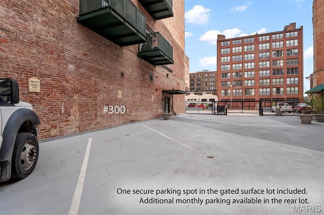 uncovered parking lot featuring fence