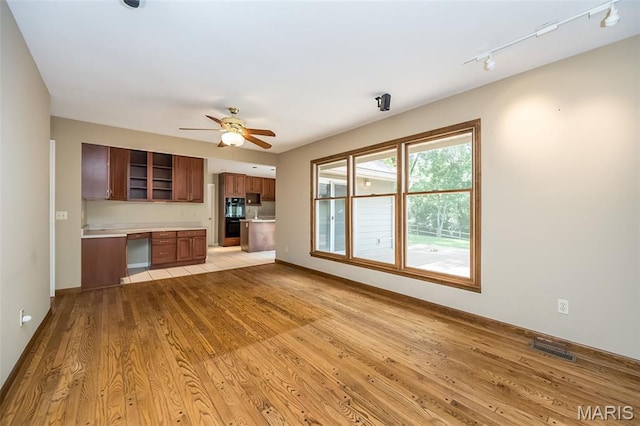 739 Muir View Dr, Ballwin, MO 63011 - unfurnished living room with a ceiling fan, light wood-style flooring, track lighting, and baseboards