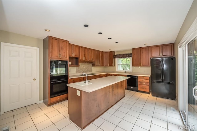 739 Muir View Dr, Ballwin, MO 63011 - kitchen with black appliances, light countertops, a kitchen island with sink, a sink, and brown cabinets