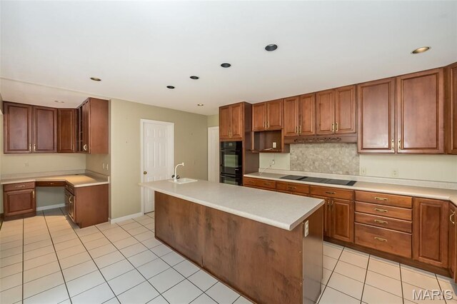 739 Muir View Dr, Ballwin, MO 63011 - kitchen featuring black appliances, a sink, light tile patterned floors, light countertops, and a kitchen island with sink