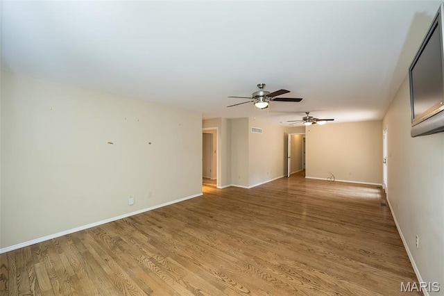 739 Muir View Dr, Ballwin, MO 63011 - spare room featuring a ceiling fan, light wood-style flooring, and baseboards