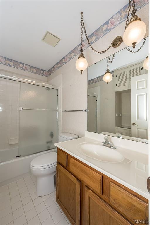739 Muir View Dr, Ballwin, MO 63011 - full bath featuring tile patterned floors, vanity, toilet, and bath / shower combo with glass door