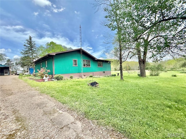 view of side of home featuring a lawn