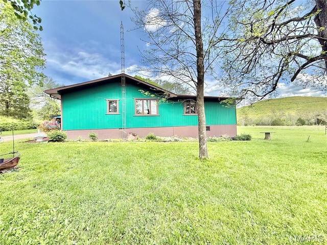 view of home's exterior with a lawn
