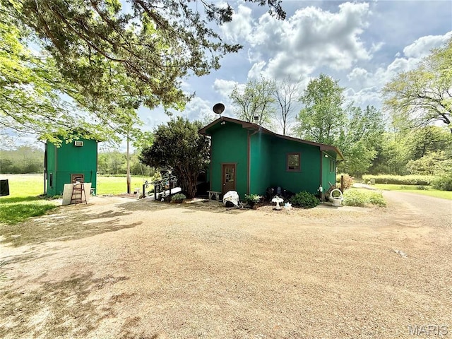view of property exterior featuring dirt driveway