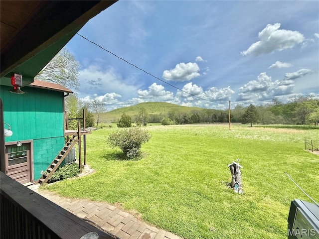 view of green lawn featuring stairway