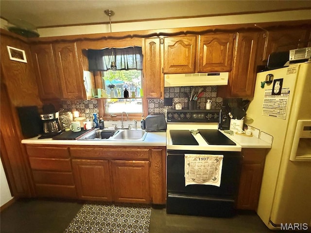 kitchen with under cabinet range hood, black / electric stove, a sink, white fridge with ice dispenser, and light countertops