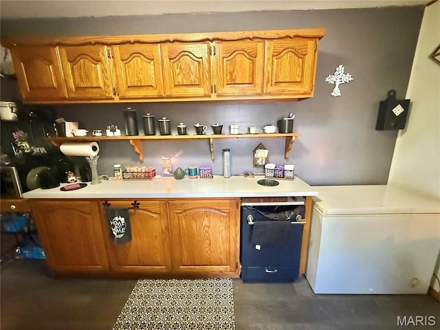 kitchen with open shelves, light countertops, brown cabinets, and concrete floors
