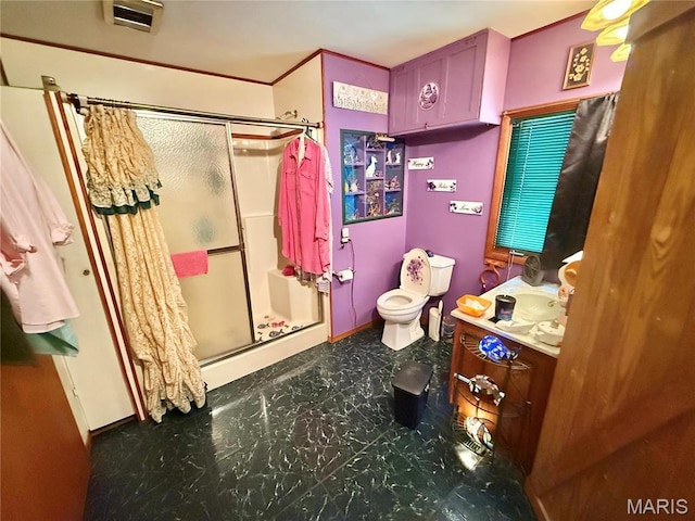 full bath featuring a stall shower, toilet, vanity, baseboards, and tile patterned floors