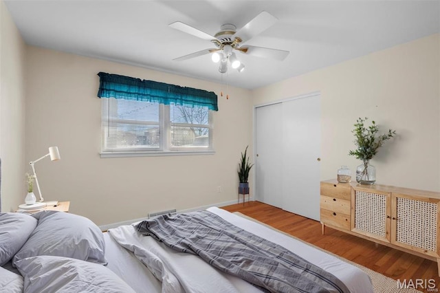 bedroom featuring wood finished floors, a closet, and ceiling fan