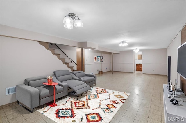 living area featuring stairway and baseboards
