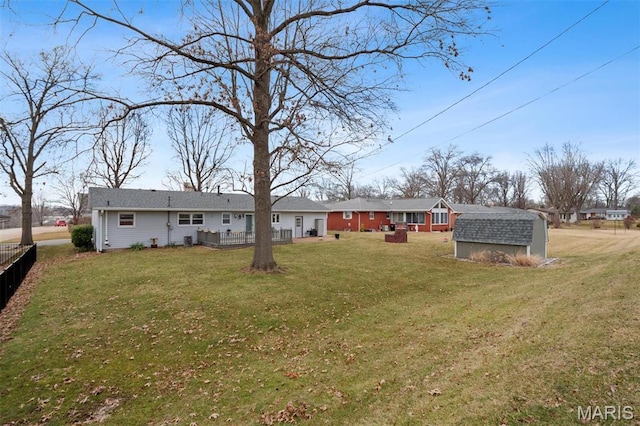 view of yard with a storage unit and an outbuilding