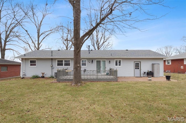 back of property featuring a lawn, a patio area, and a wooden deck