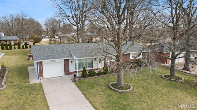 ranch-style home featuring brick siding, an attached garage, driveway, and a front yard