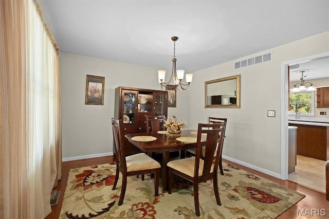 109 Pleasant Ridge Dr, Edwardsville, IL 62025 - dining area featuring a chandelier, light wood-style floors, and baseboards