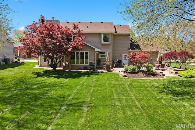 109 Pleasant Ridge Dr, Edwardsville, IL 62025 - back of property featuring a patio area, a lawn, and cooling unit