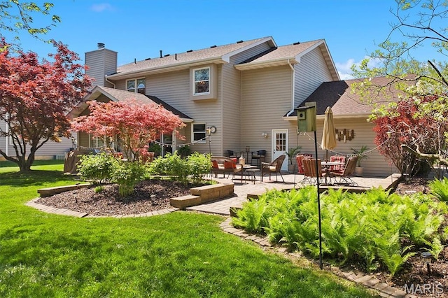 109 Pleasant Ridge Dr, Edwardsville, IL 62025 - back of property with a patio, a lawn, a chimney, a shingled roof, and an outdoor hangout area