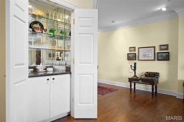800 S Hanley Rd Unit 2D, Saint Louis, MO 63105 - bar with ornamental molding, dark wood-style flooring, and baseboards