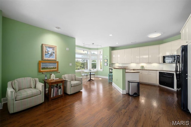 800 S Hanley Rd Unit 2D, Saint Louis, MO 63105 - kitchen featuring black appliances, white cabinetry, dark wood-style flooring, baseboards, and a center island