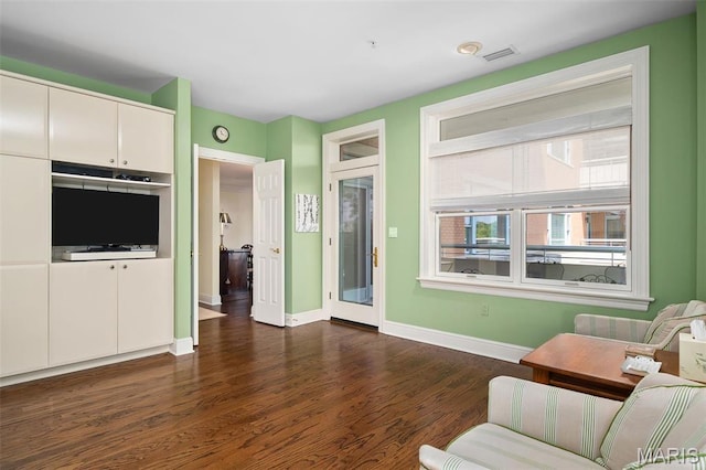 800 S Hanley Rd Unit 2D, Saint Louis, MO 63105 - living area featuring baseboards and dark wood-style flooring