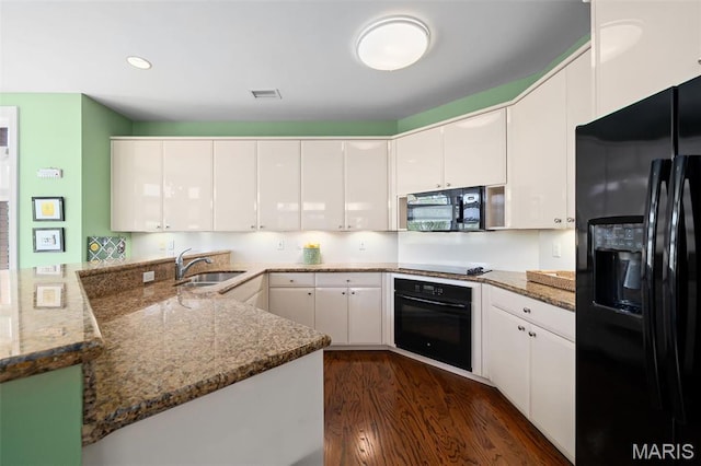800 S Hanley Rd Unit 2D, Saint Louis, MO 63105 - kitchen with black appliances, a sink, dark wood-style floors, white cabinets, and light stone countertops