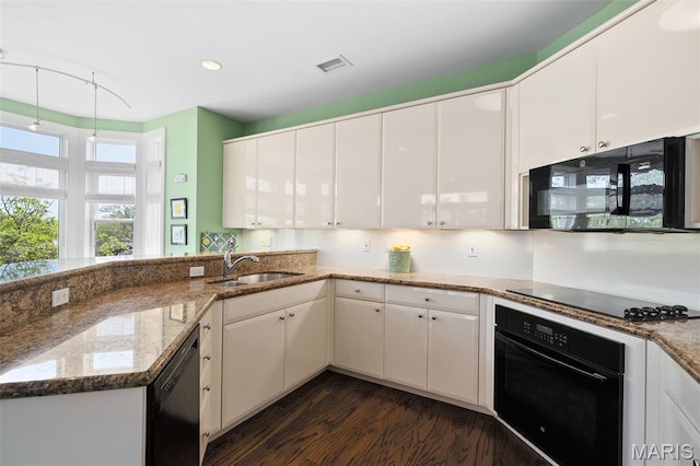 800 S Hanley Rd Unit 2D, Saint Louis, MO 63105 - kitchen featuring black appliances, a sink, dark wood finished floors, white cabinets, and light stone countertops