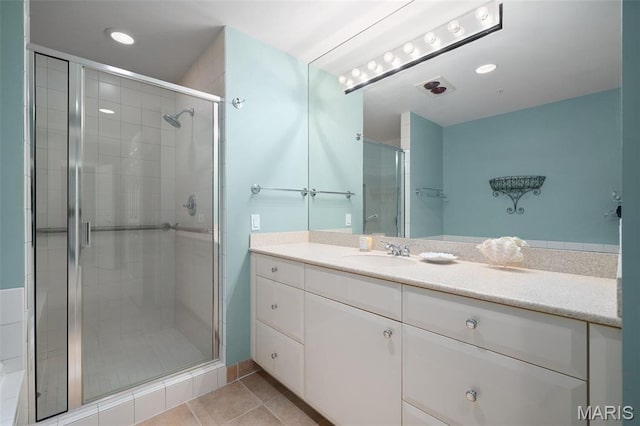 800 S Hanley Rd Unit 2D, Saint Louis, MO 63105 - bathroom with a stall shower, tile patterned floors, vanity, and recessed lighting