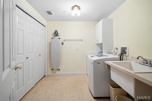 800 S Hanley Rd Unit 2D, Saint Louis, MO 63105 - clothes washing area featuring cabinet space, baseboards, and washing machine and dryer