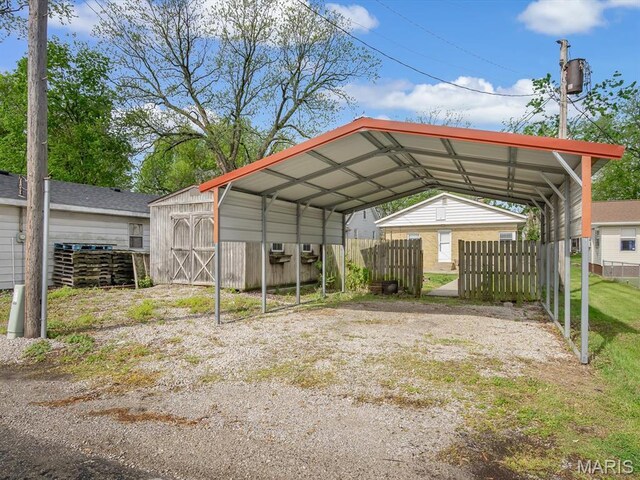 422 Washington St, Red Bud, IL 62278 - view of parking / parking lot with a shed, fence, a detached carport, and driveway