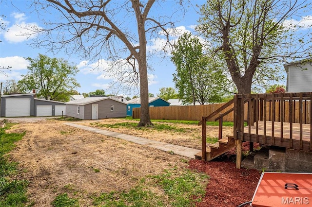 306 Walnut St, Waterloo, IL 62298 - view of yard featuring a garage, a wooden deck, and an outbuilding
