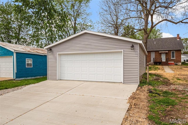 306 Walnut St, Waterloo, IL 62298 - view of front of house with a detached garage, an outdoor structure, a chimney, and brick siding