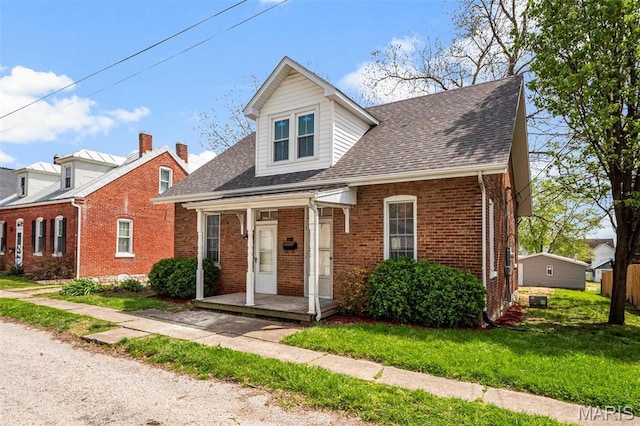 306 Walnut St, Waterloo, IL 62298 - view of front of home featuring brick siding, roof with shingles, and a front yard