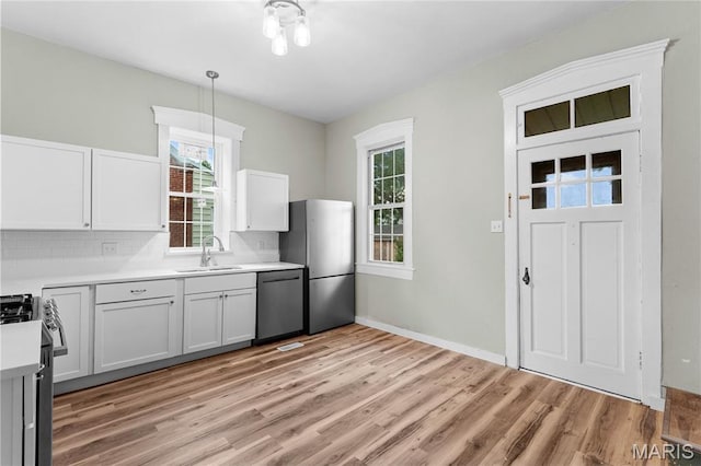306 Walnut St, Waterloo, IL 62298 - kitchen featuring dishwashing machine, a sink, freestanding refrigerator, range with gas stovetop, and light wood-style flooring