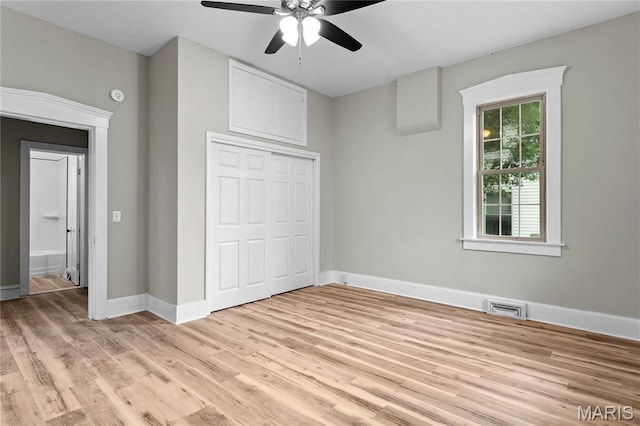 306 Walnut St, Waterloo, IL 62298 - unfurnished bedroom featuring light wood-style floors, a closet, baseboards, and ceiling fan