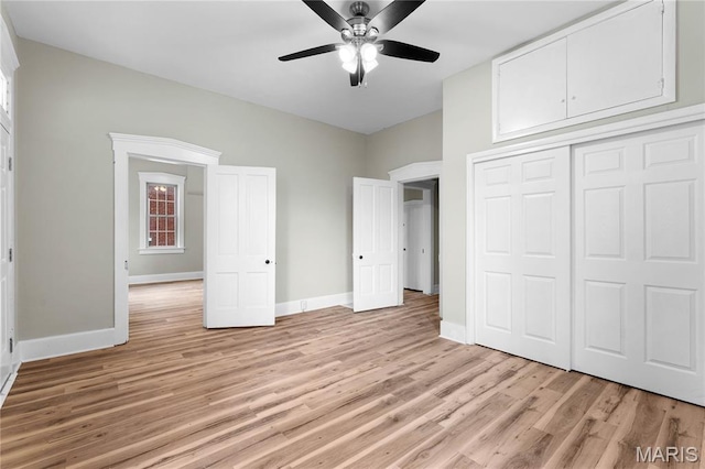 306 Walnut St, Waterloo, IL 62298 - unfurnished bedroom with light wood finished floors, baseboards, a closet, and ceiling fan