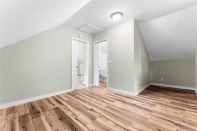 306 Walnut St, Waterloo, IL 62298 - bonus room featuring vaulted ceiling, light wood-style flooring, attic access, and baseboards