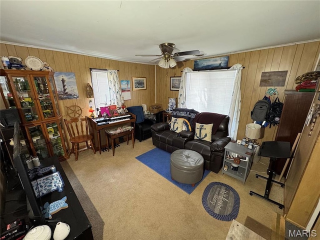 619 Frankford Rd, Louisiana, MO 63353 - living area featuring carpet floors, wood walls, ceiling fan, and ornamental molding