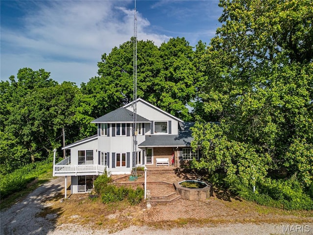 634 N 200th St, Vandalia, IL 62471 - view of front of house with a sunroom and board and batten siding