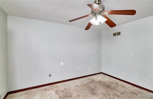 spare room featuring ceiling fan, carpet floors, a textured ceiling, and baseboards