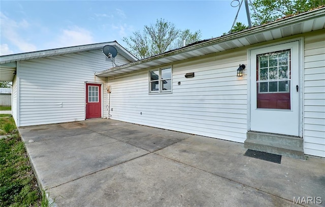 view of property exterior featuring a patio area and entry steps