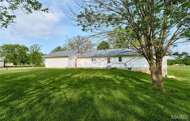 view of home's exterior with a lawn