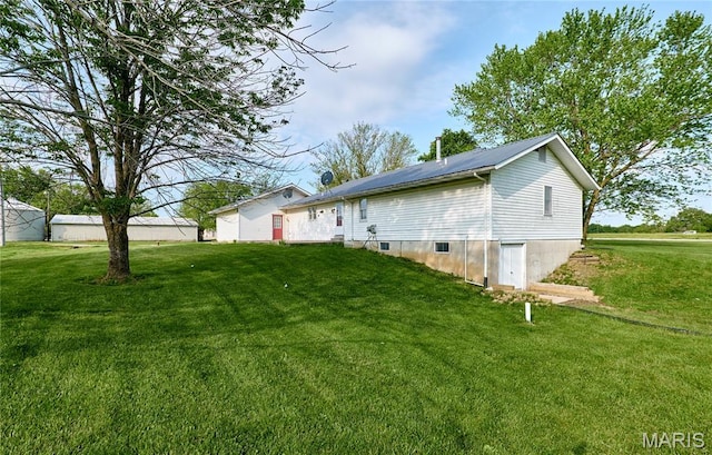rear view of house with a yard