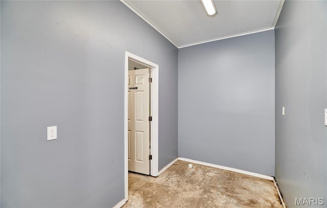 unfurnished room featuring ornamental molding, unfinished concrete flooring, and baseboards